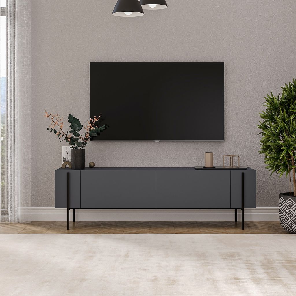 A modern living room with a TV stand and television.