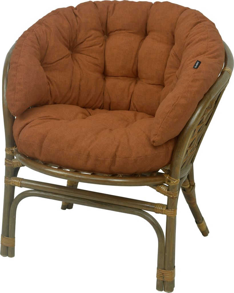 A brown cushion on a rattan chair.