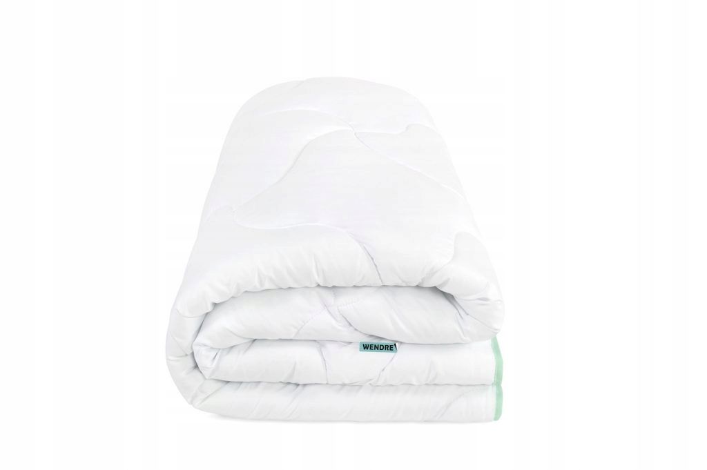A white duvet is folded and placed on a white background.