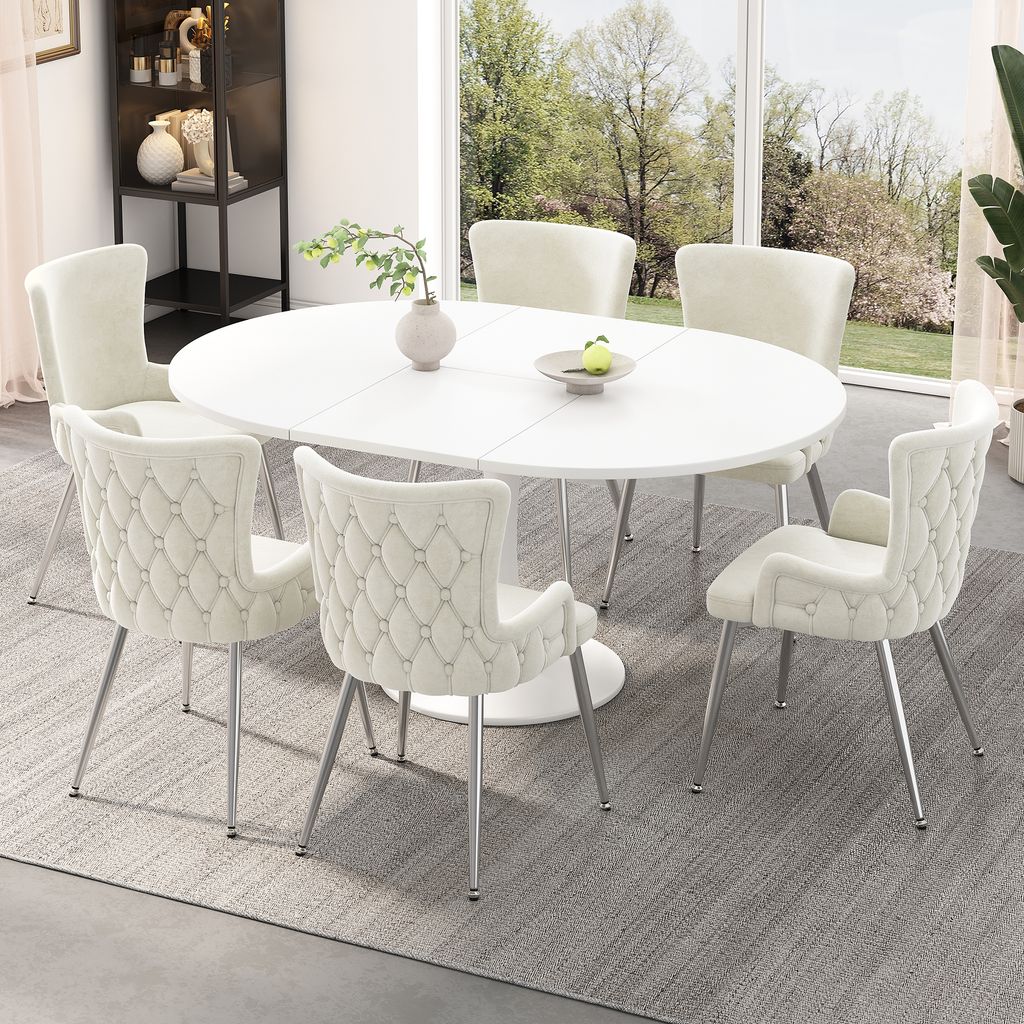 A dining set with an oval table and chairs in a well-lit room with a large window overlooking a garden.