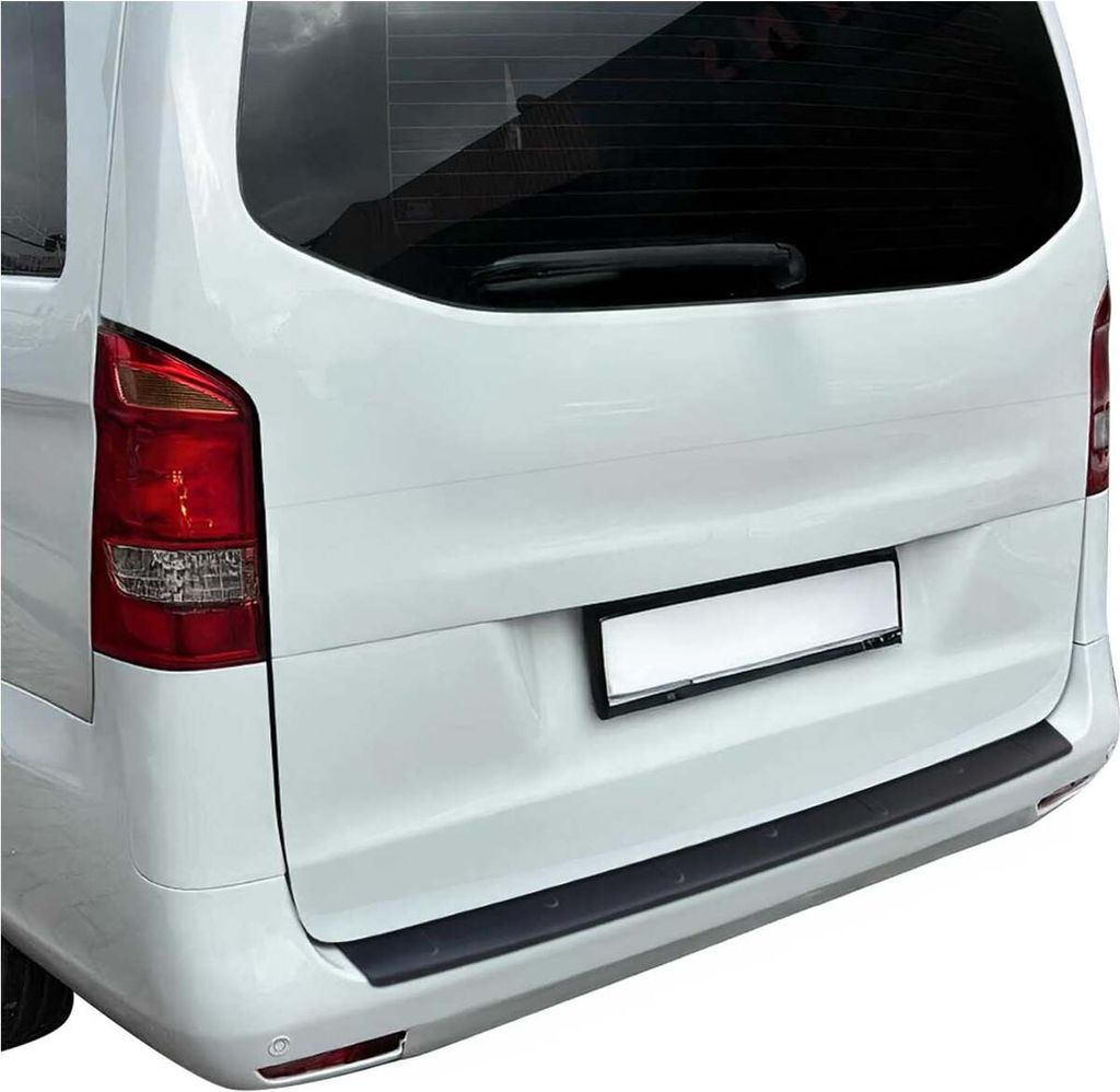 The rear of a white van with a black bumper protector installed.