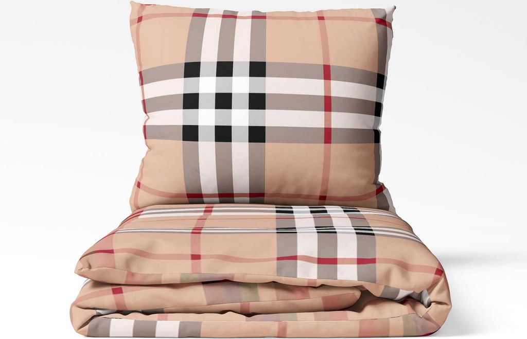 A folded duvet and a pillow with a plaid pattern.