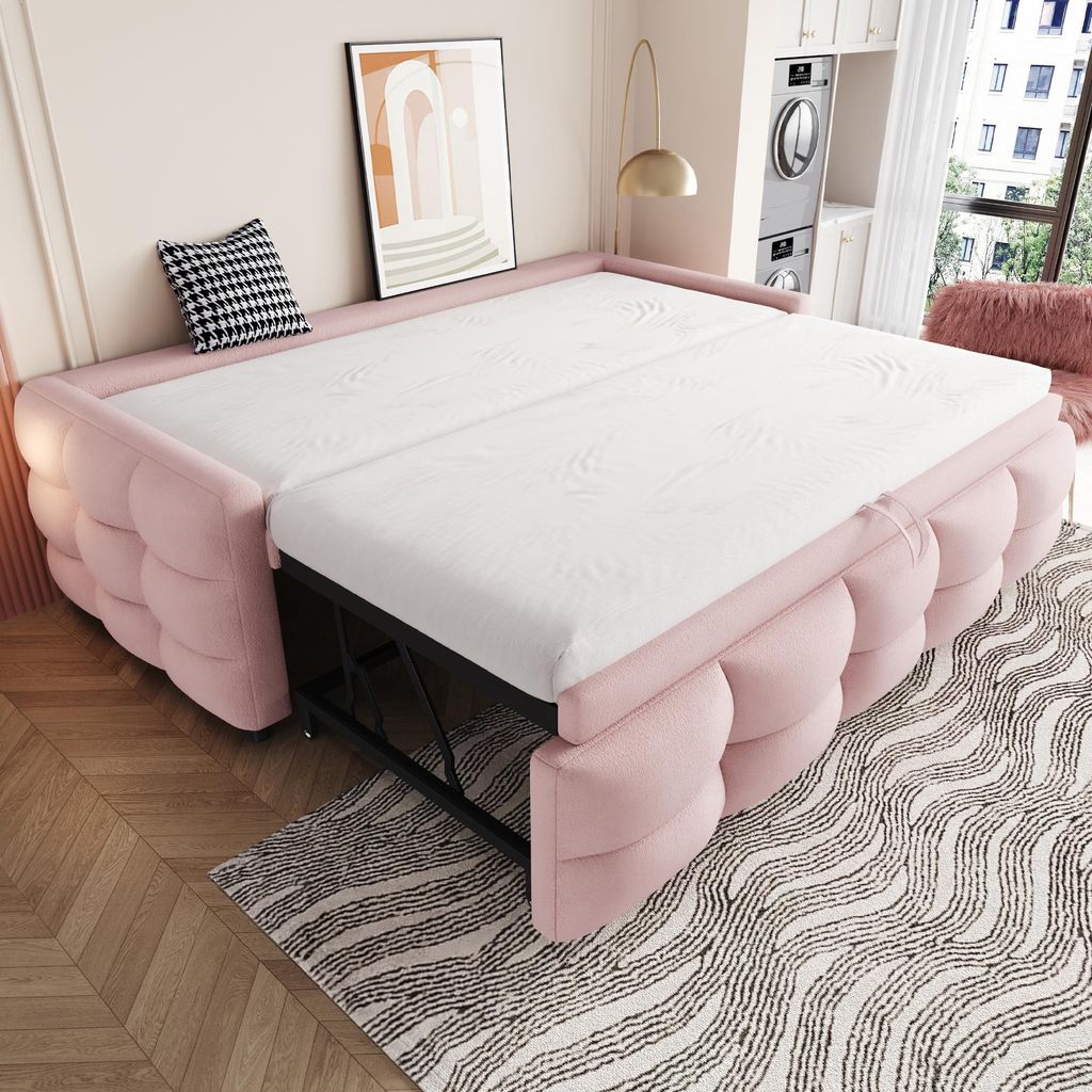 A pink sofa bed is shown in an expanded state, resembling a mattress on a frame. The room has a light pink wall and a wooden floor.