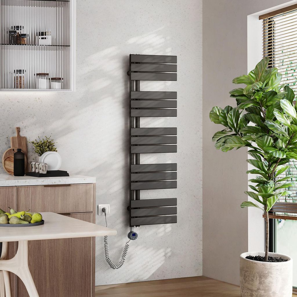 A modern kitchen or bathroom setting with a towel warmer, cabinets, and a plant.