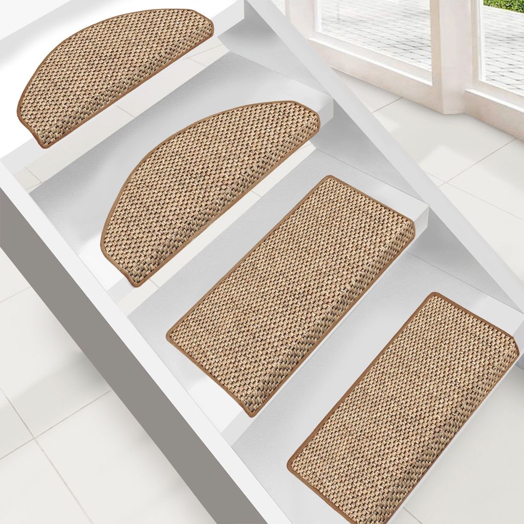 Several stair mats are placed on white stairs.