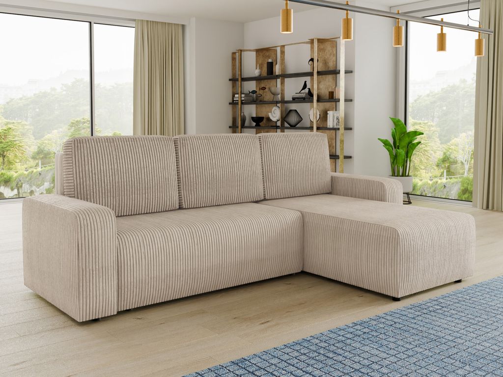 A beige corduroy sectional sofa is shown in a well-lit living room with a large window overlooking a natural landscape.