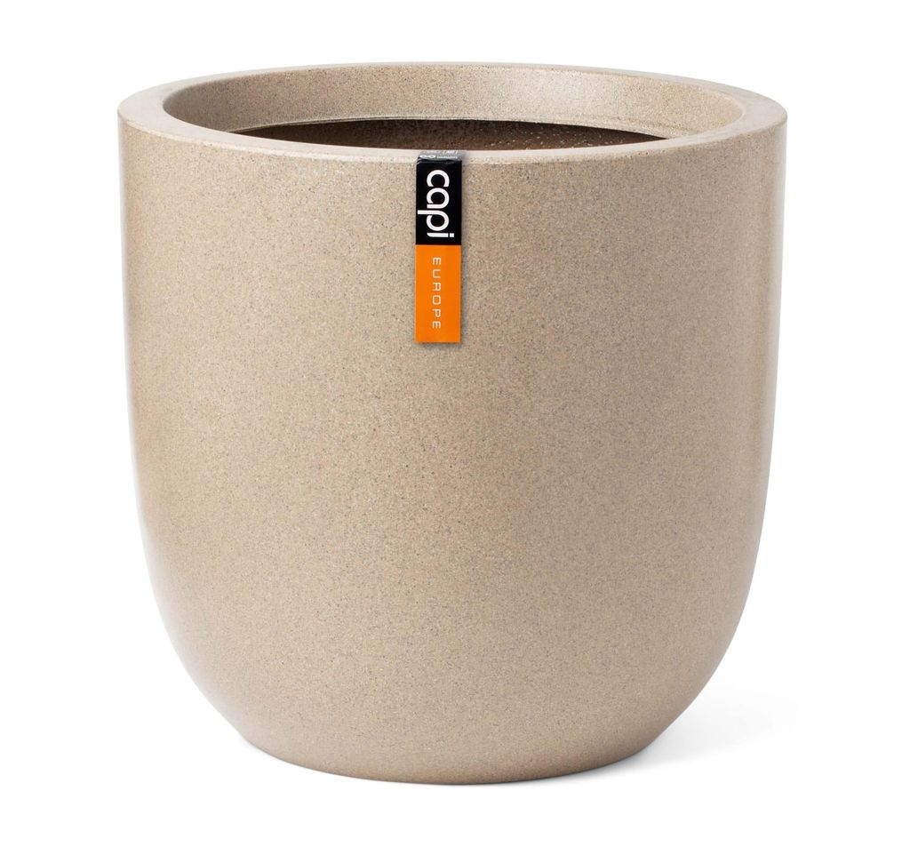 A beige speckled planter pot with a brand label.