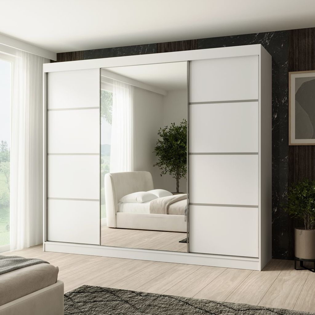 A white sliding door wardrobe with mirrored doors, reflecting a bedroom interior.