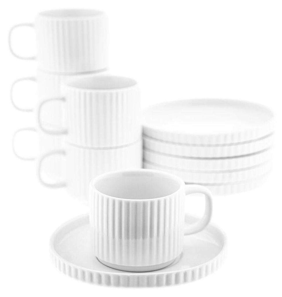 A set of white porcelain mugs and saucers are neatly arranged.