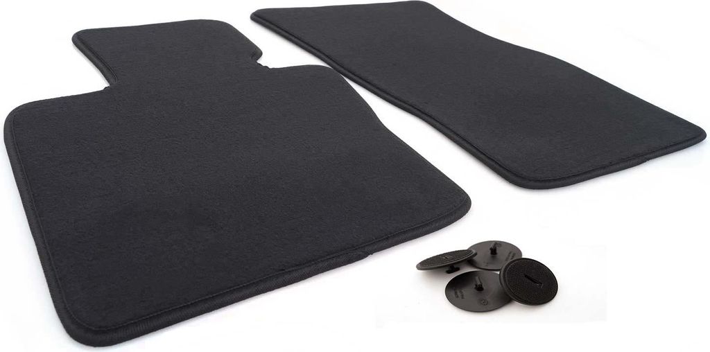 A pair of black car floor mats and securing clips on a white background.