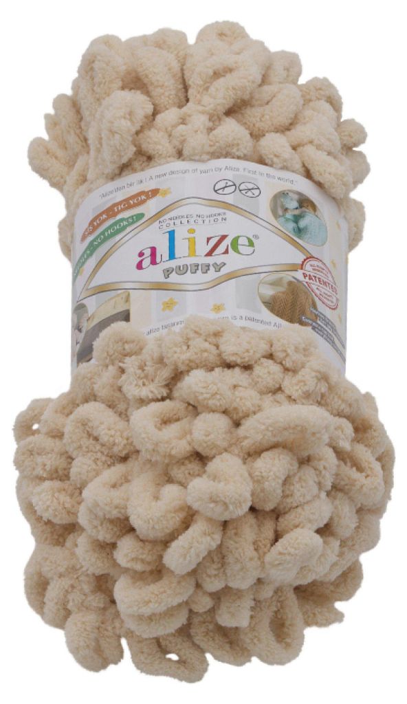 A ball of beige yarn with loops, on a white background.