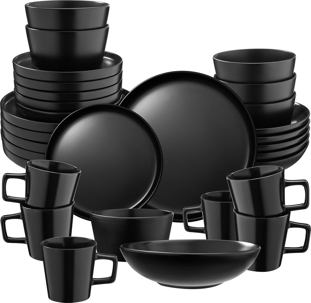 A collection of black ceramic dinnerware, including plates, bowls, and mugs, neatly arranged.