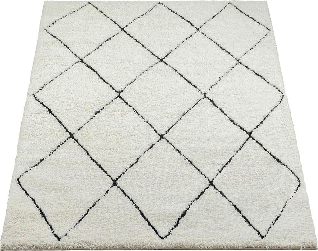 A cream-colored rug with a black diamond pattern, shown from a slightly elevated angle on a white background.
