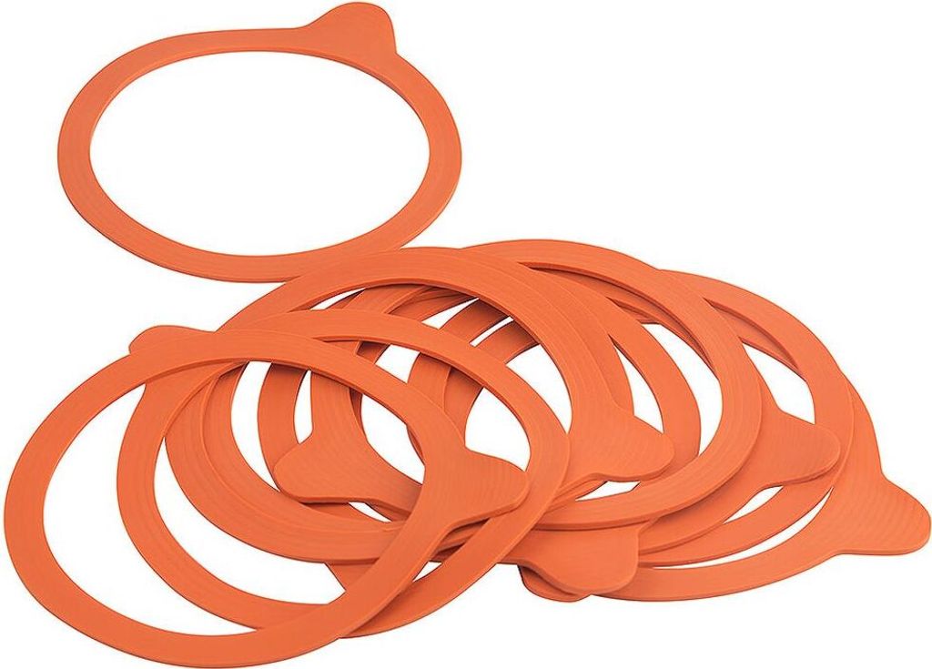A pile of orange rubber sealing rings for canning jars.