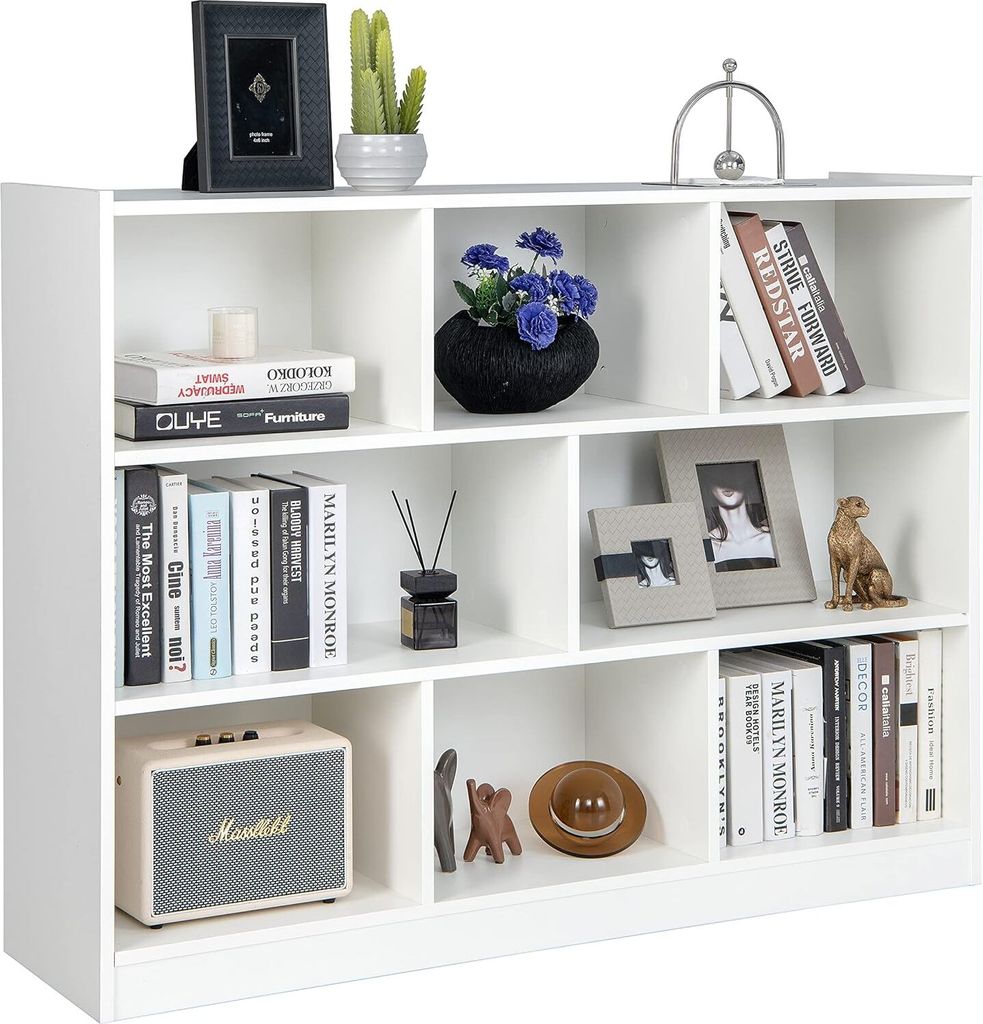 A white bookshelf filled with various decorative items and books.