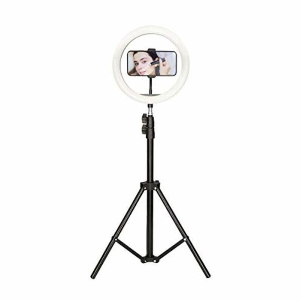 A ring light with a smartphone holder and a smartphone displaying a person applying makeup.