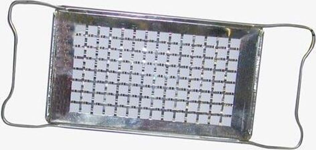 A metal grater with a grid of small square holes.