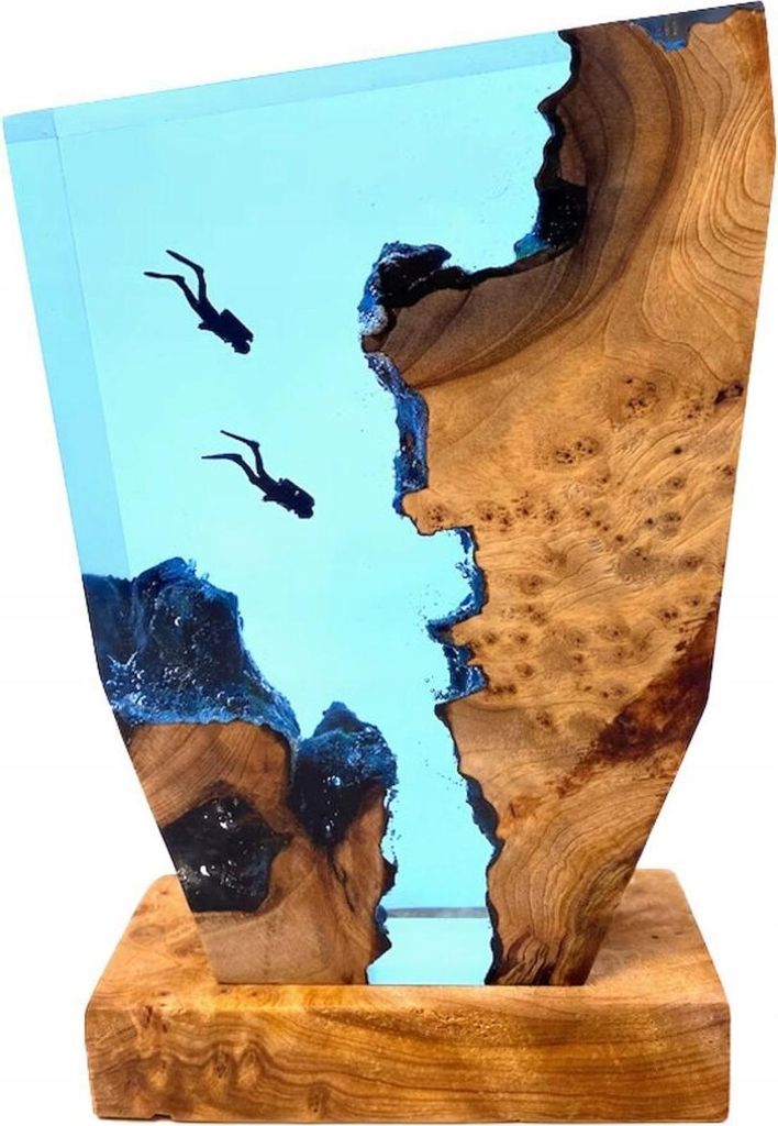 A decorative sculpture of divers underwater, made from wood and epoxy resin.