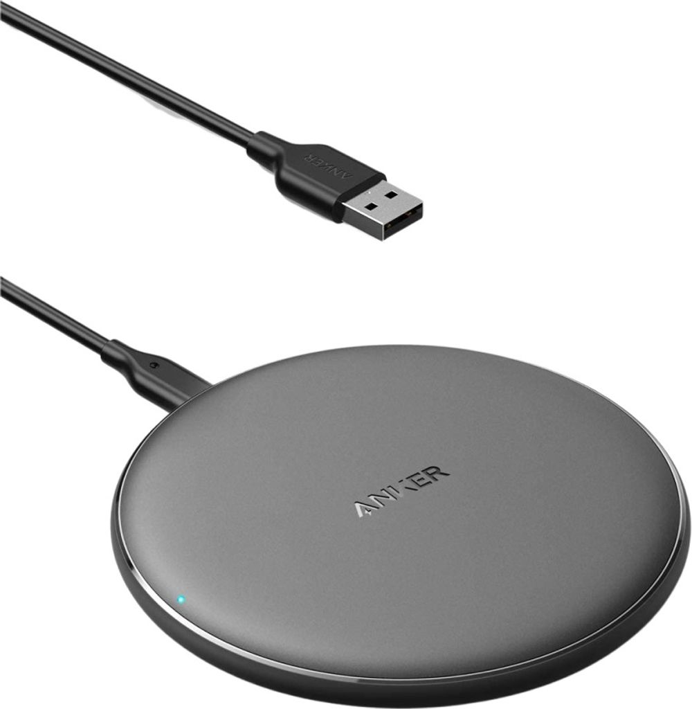 A black wireless charging pad with a USB cable on a white background.