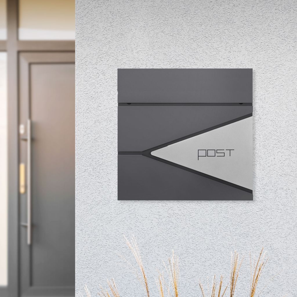 A modern mailbox mounted on a textured wall next to a door.