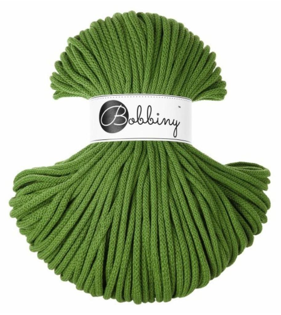 A spool of green yarn with a label.