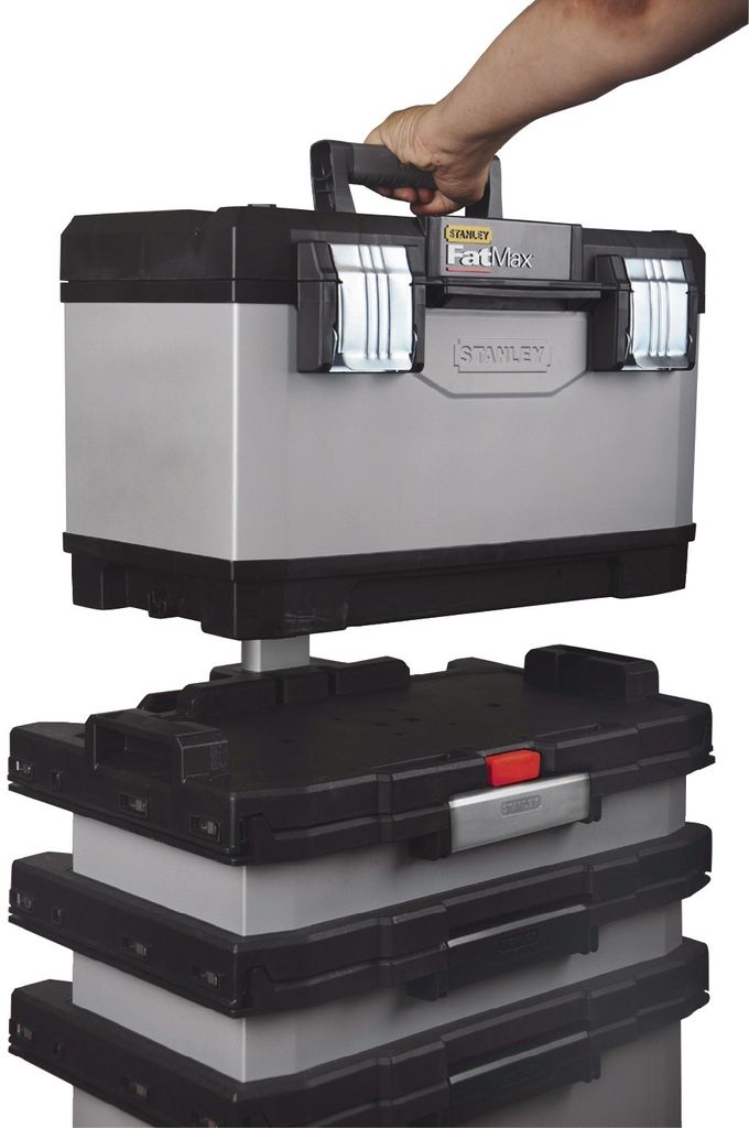 A hand is holding the top of a modular toolbox system, which is stacked on top of other similar toolbox modules.