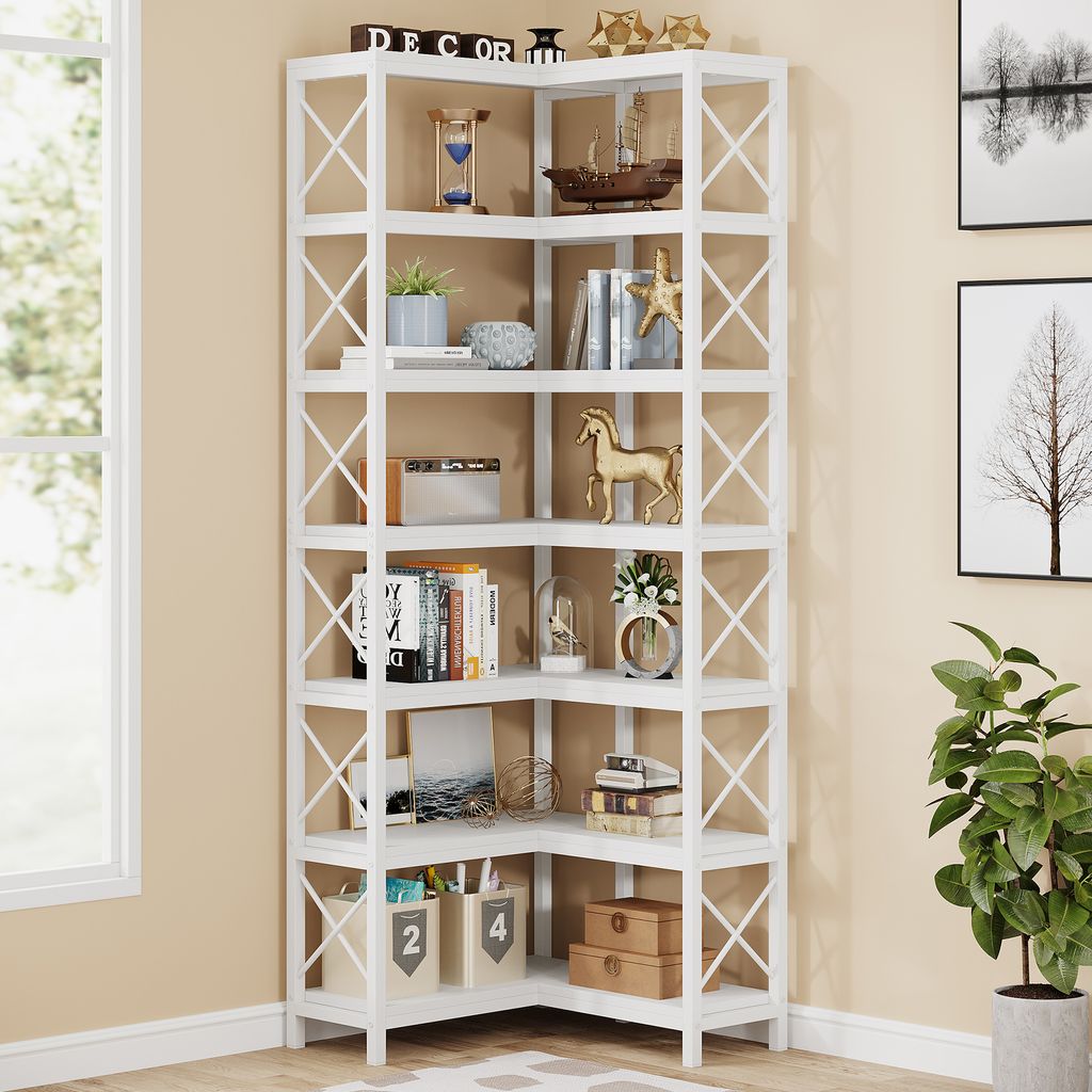 A white corner bookshelf filled with various decorative items and books.