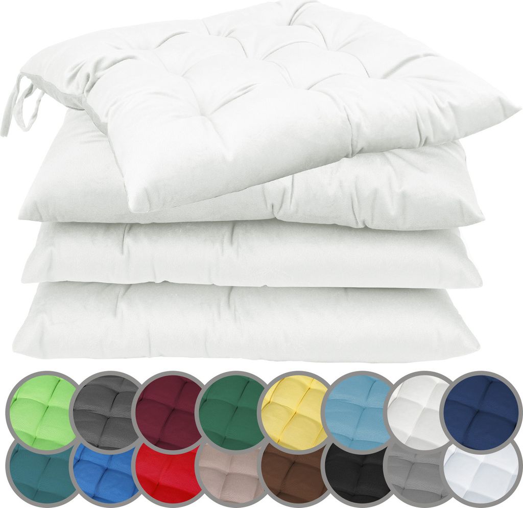 A stack of white seat cushions with a row of colored swatches below.