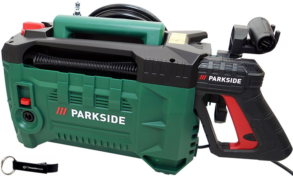 A green and black pressure washer with a red accent on the handle, shown against a white background. A black keychain with a white logo is visible in the bottom left corner.