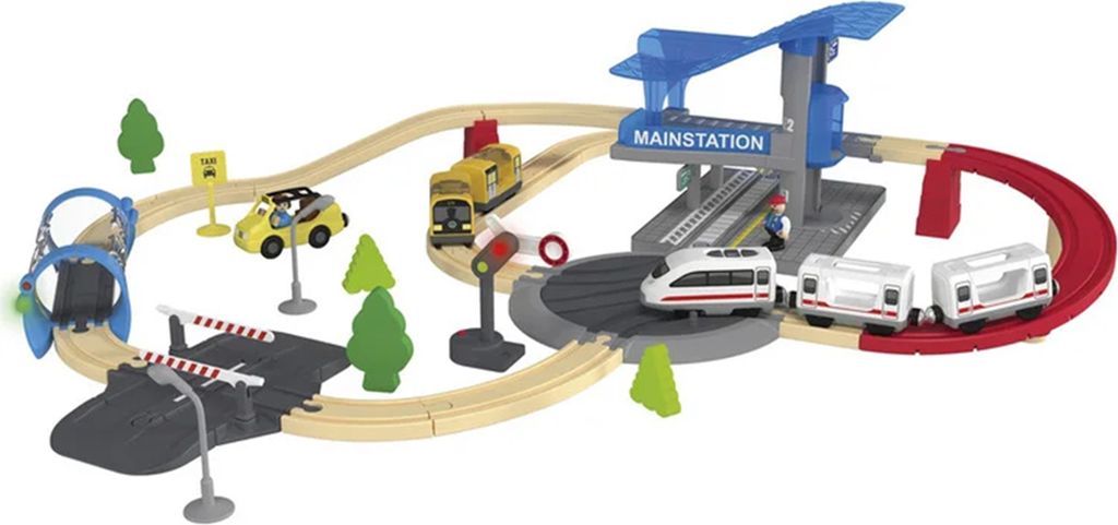 A toy train set with tracks, a station, trains, a car, and trees.