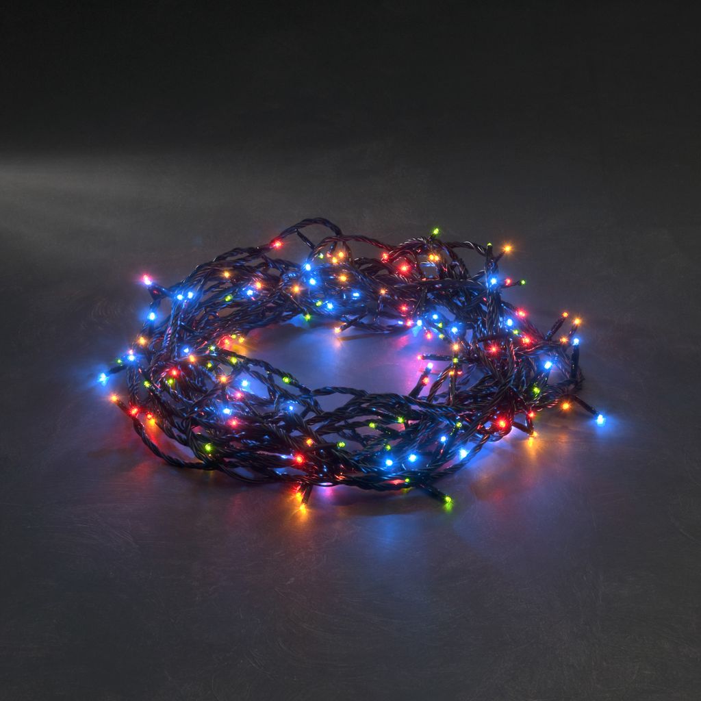 A coiled string of colorful LED lights on a dark surface.