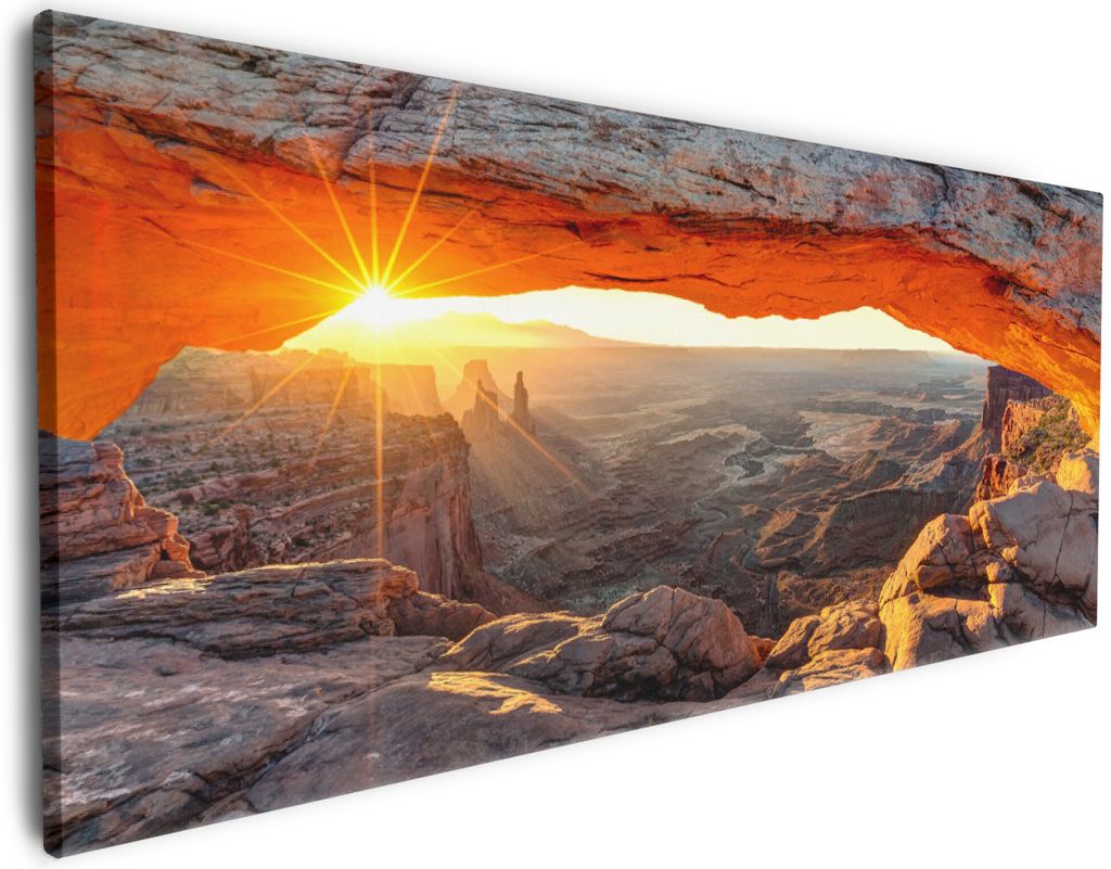 Wallario Premium Leinwandbild Sonnenstrahl am Horizont Leuchtende Felsspalte in Größe 50 x 125 cm