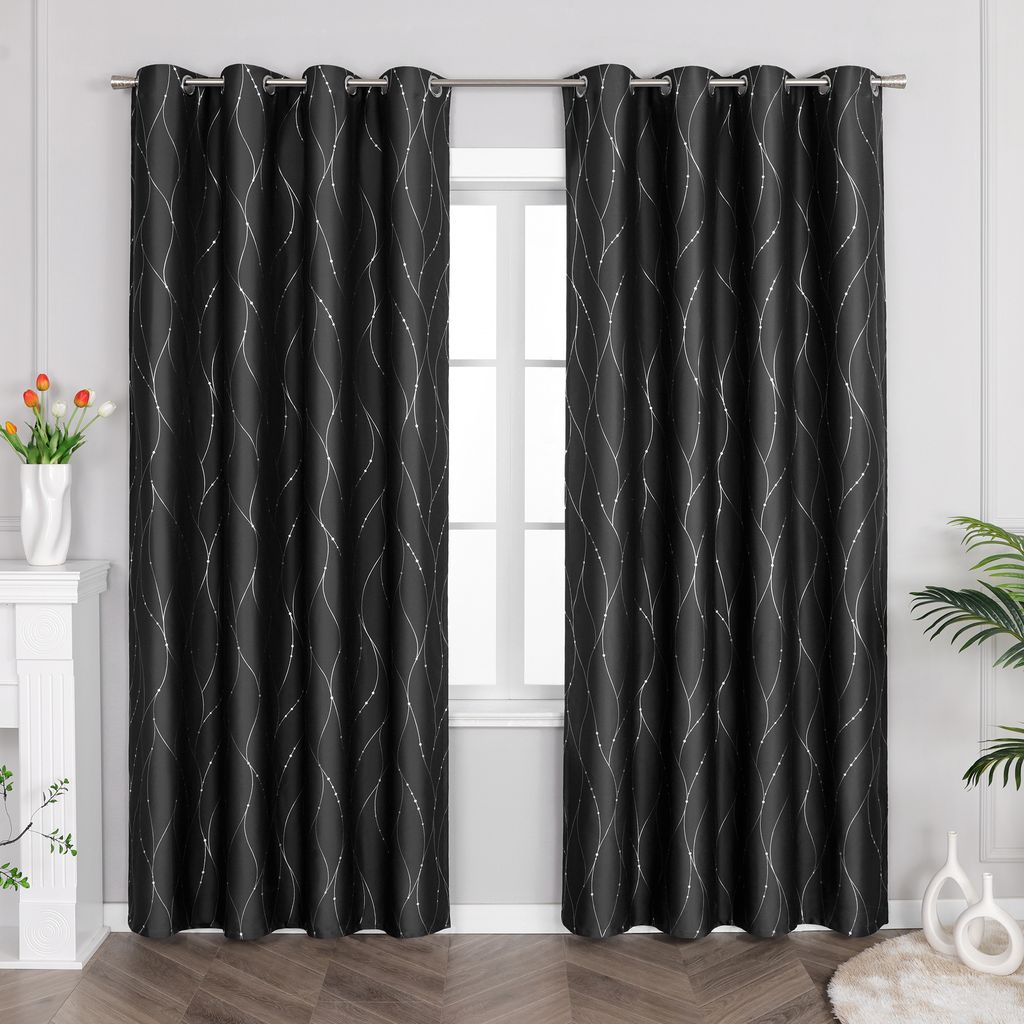 A pair of black curtains with silver wavy stripes hanging in front of a window.