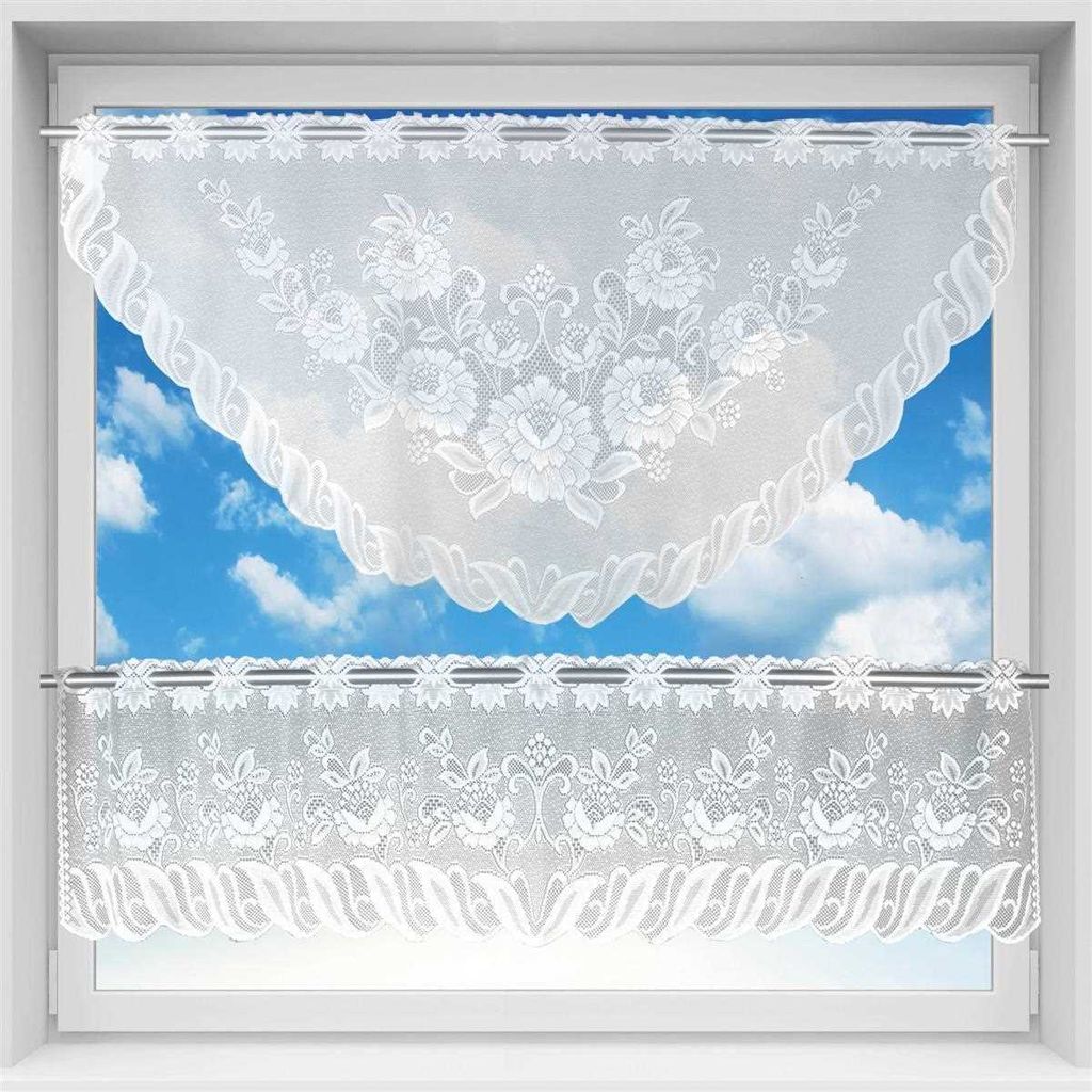 A window with white lace curtains hanging.