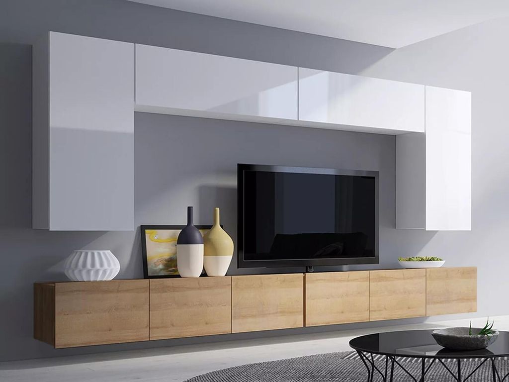 A modern living room wall unit with a TV and decorative items.