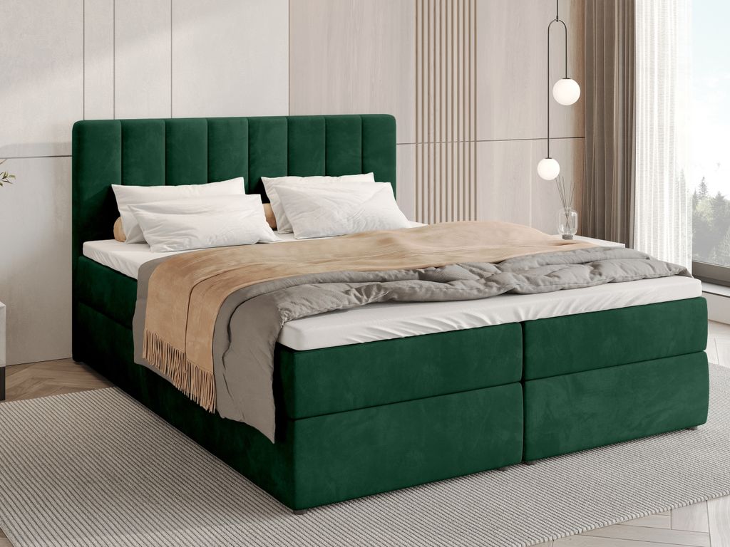A green upholstered bed with white bedding and a beige throw blanket is shown in a bedroom setting.