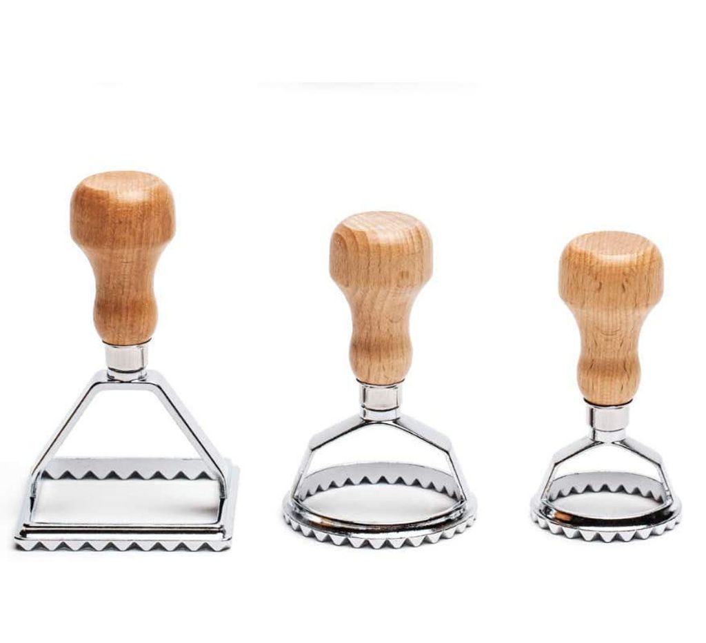 Three pasta cutters of different shapes and sizes are arranged in a row against a white background.