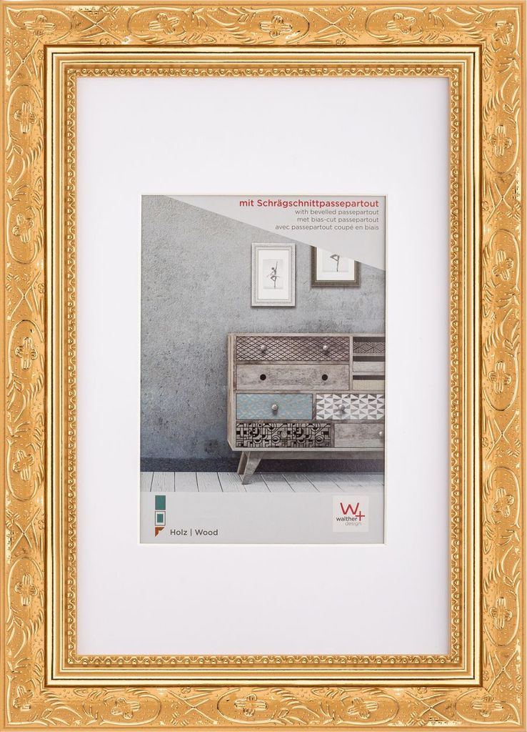 A gold baroque wooden picture frame with a white mat and a sample image inside.