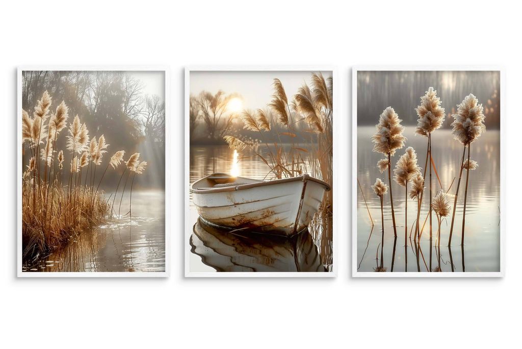 A triptych of framed posters depicting a serene lake scene with reeds and a boat at sunset.