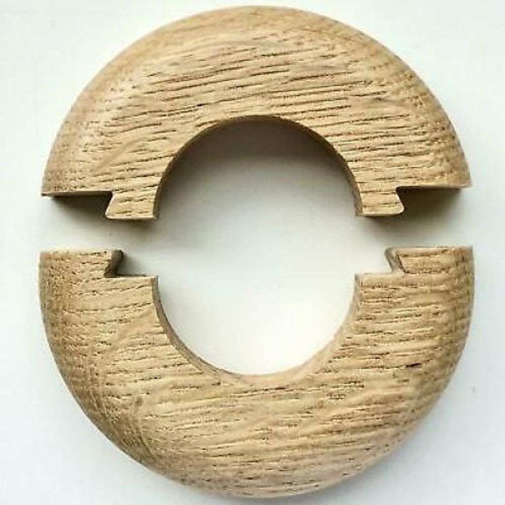 Two wooden pieces of a radiator rosette are shown against a white background.