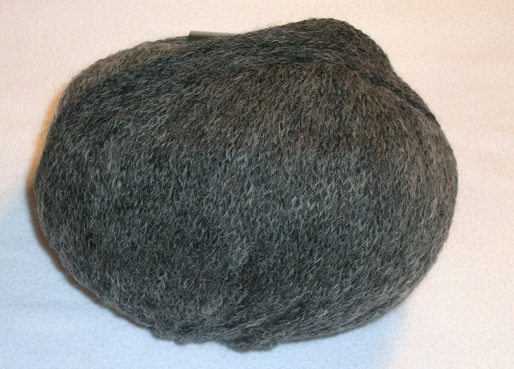 A ball of grey yarn on a white surface.