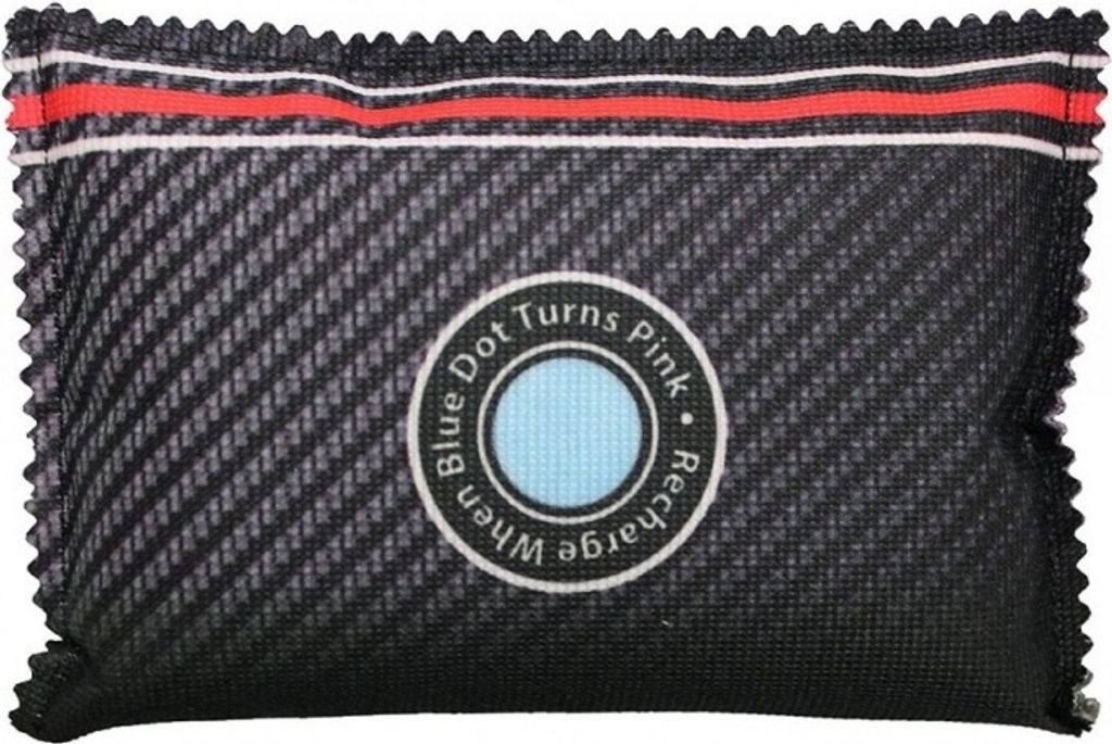 A desiccant packet with a carbon fiber-like texture and a circular indicator.