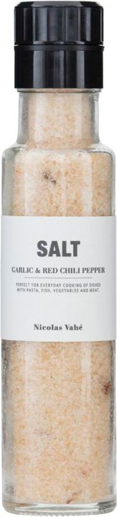 A clear, well-lit studio shot of a glass bottle filled with salt, with a black cap and a white label.