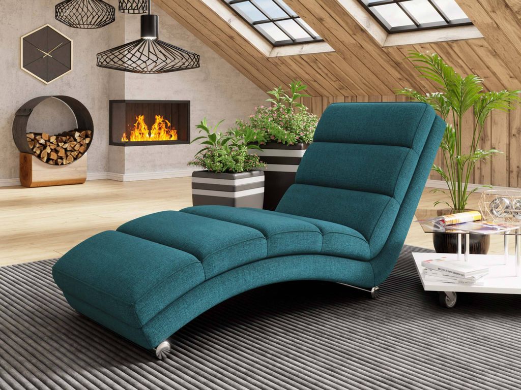 A teal chaise lounge is placed in a modern living room with a fireplace and skylights.