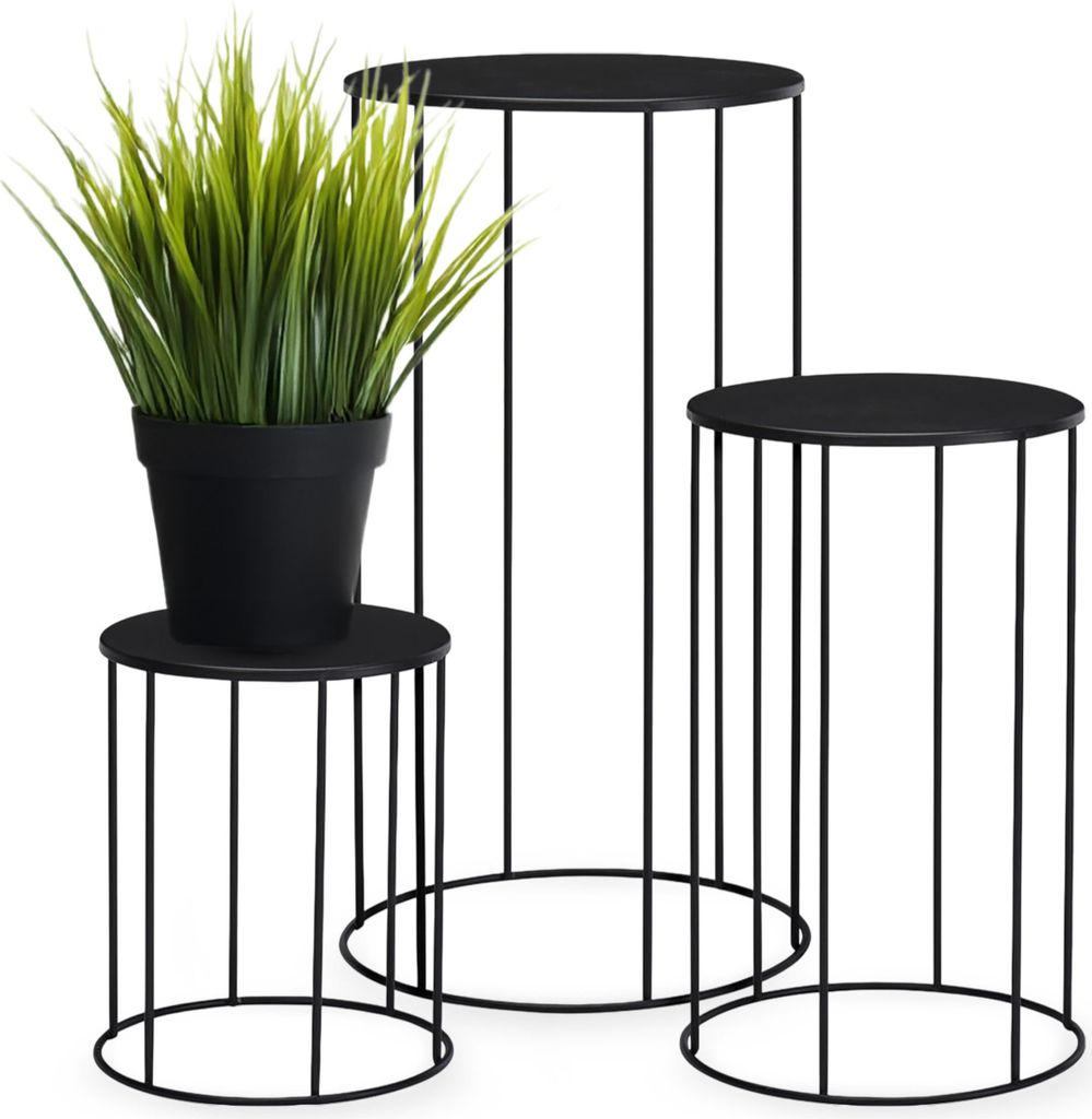 Three black metal plant stands of varying heights, with a potted artificial plant on the smallest stand.