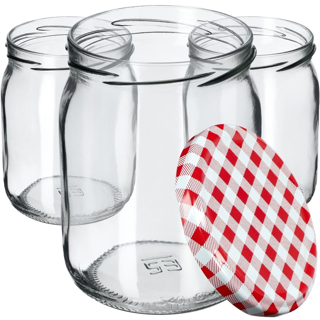 Several empty glass jars are arranged together, with one red and white checkered lid in the foreground.
