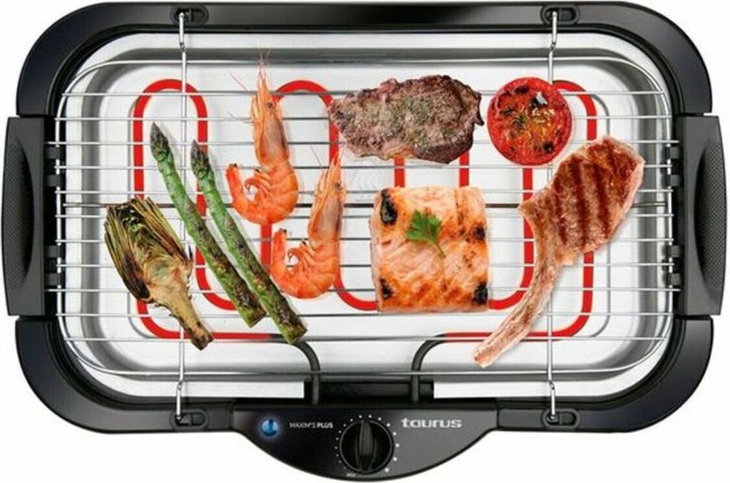 An electric grill with various foods cooking on it.