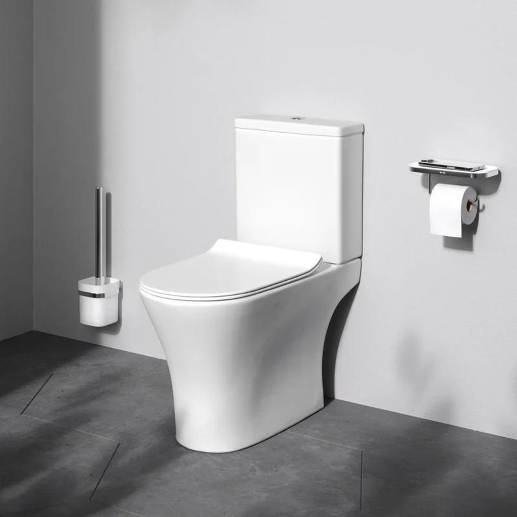 A white toilet with a toilet brush holder and a toilet paper holder with a phone stand.