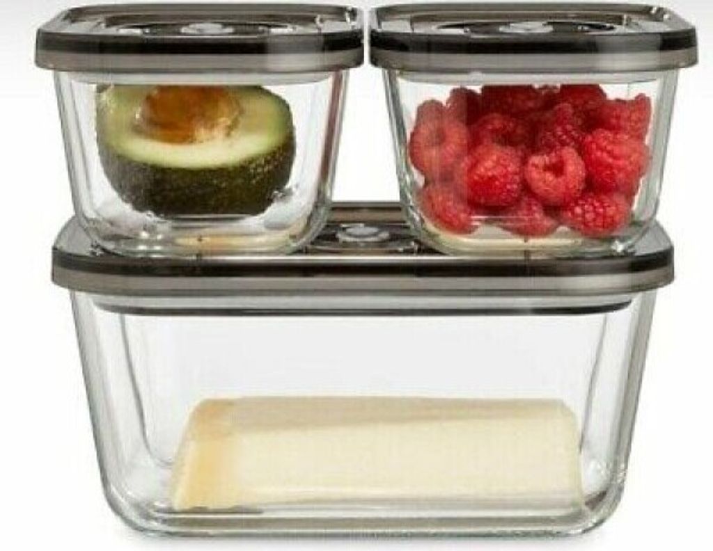 A set of three glass vacuum seal food storage containers, stacked, with food inside.