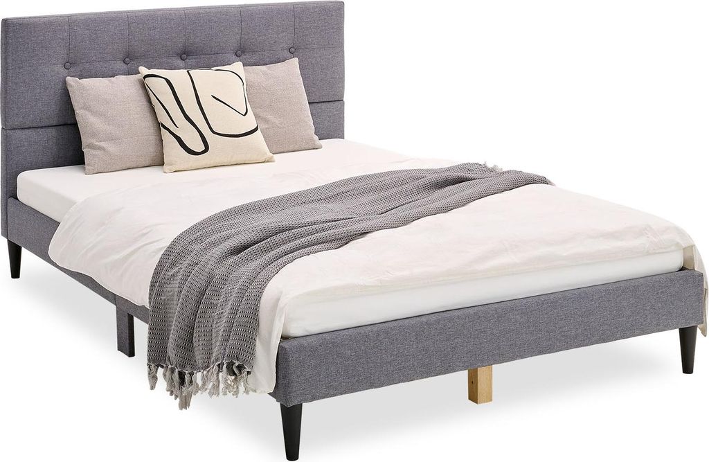 A bed with pillows and a blanket, set against a white background.